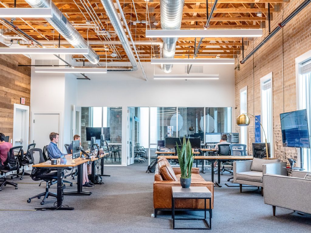 entreprise décorés façon industrielle avec bureaux canapé et plante